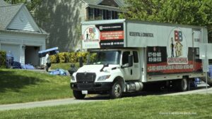 Local movers carrying boxes into a Severna Park MD home during a smooth residential move